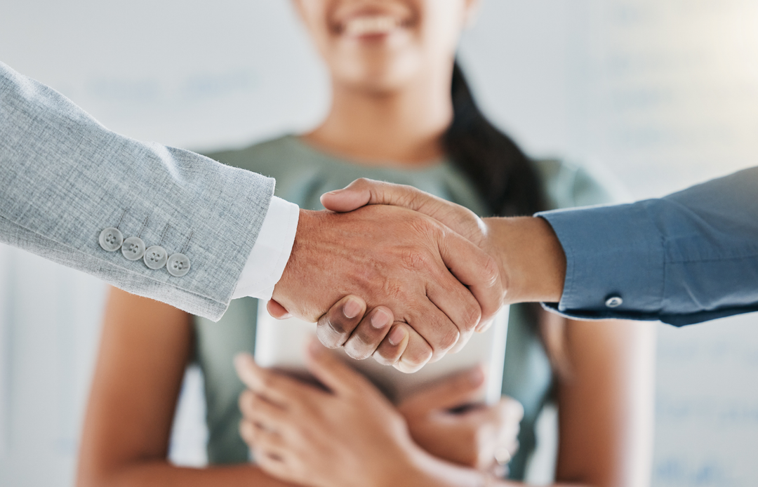 Two people shaking hands to mark the start of a new professional relationship or role