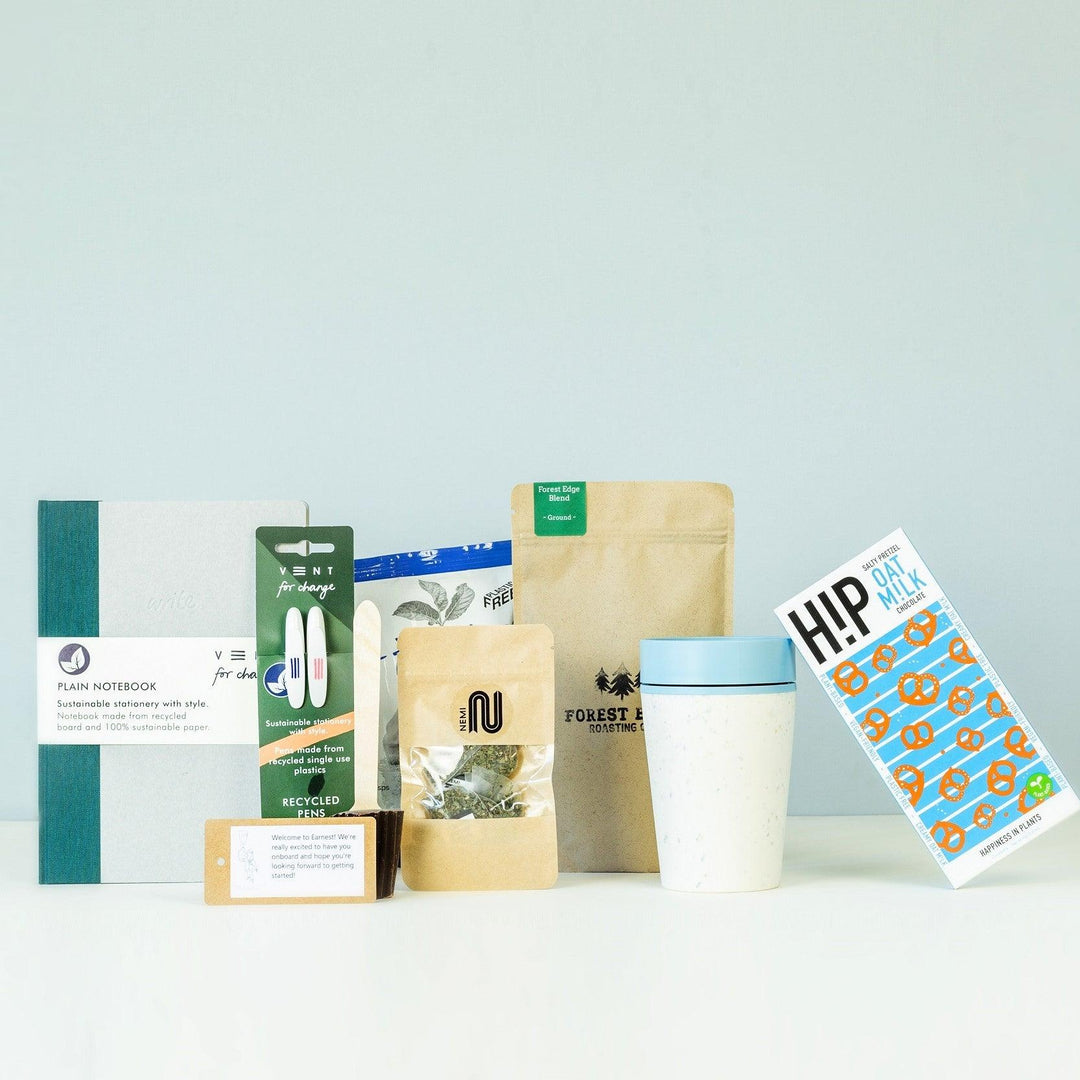 Employee onboarding gift set with personalised stationery, branded treats, and welcome essentials arranged neatly for a new starter.